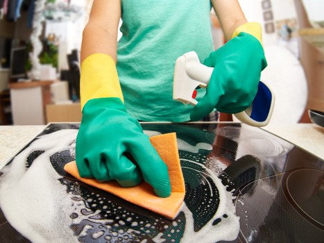 Technician removing stains during carpet cleaning