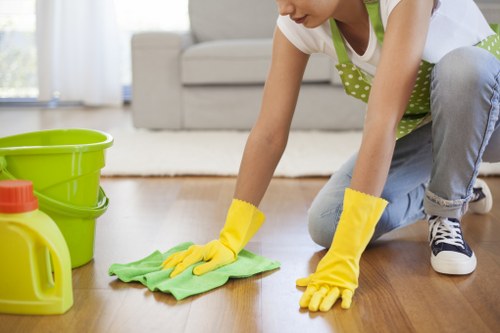 Technician performing upholstery cleaning on a fabric chair