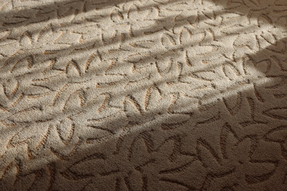 Close-up image of a textured floor surface, potentially made of stone or ceramic tiles, showing visible mould spots and dark patches indicating moisture or mould growth. The surface appears dusty and